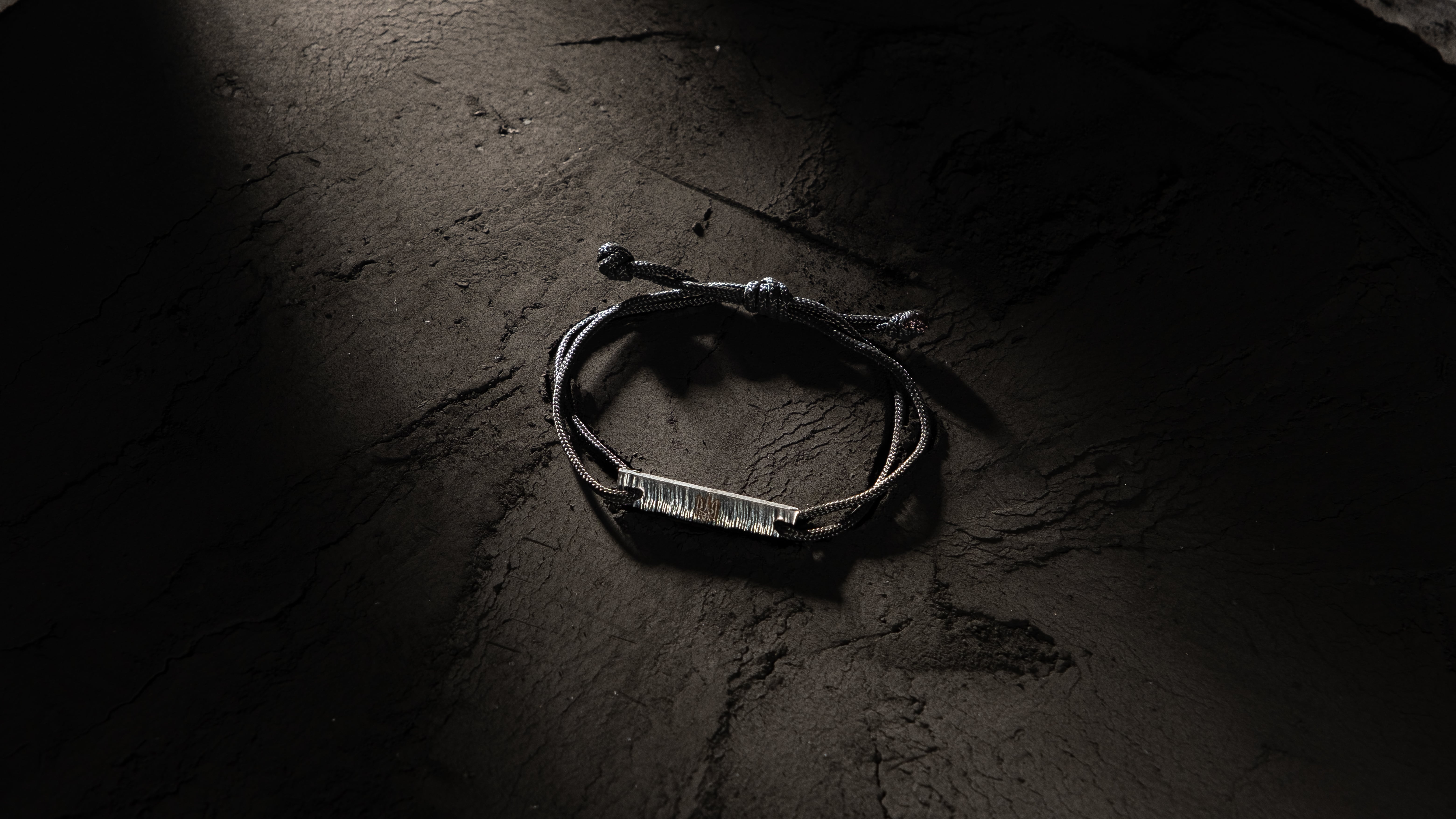 A photo of a bracelet on a black background (designed by SOVA)